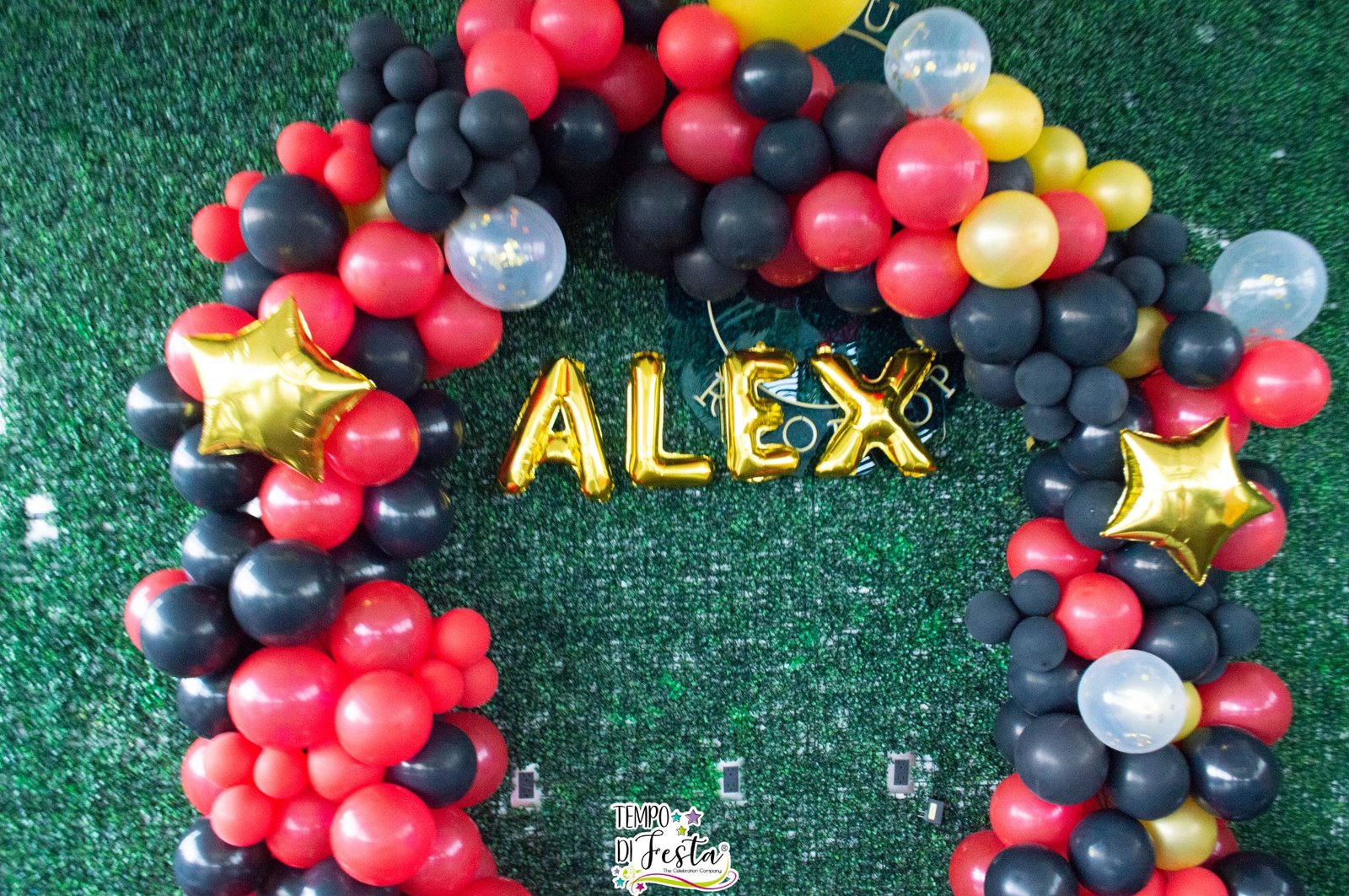 Arco de globos en negro, rojo y dorado con nombre Alex